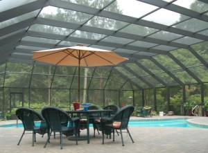 A large pool enclosure with a seating area
