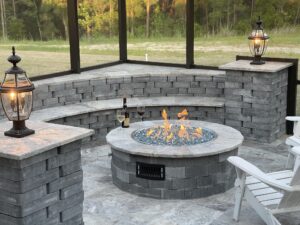 round fire pits made with stones in the backyard of the house shown in the picture