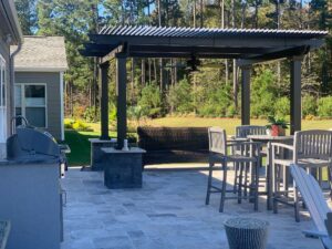 A freestanding pergola on the patio area of a home