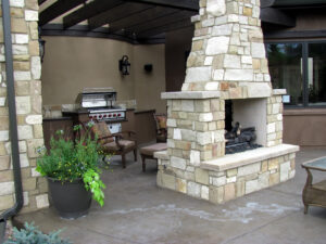 Outdoor kitchen with a brick fireplace