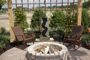 Beautiful backyard with a cozy fire pit and fountain